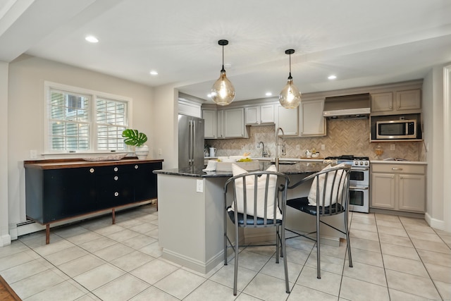 158 Linden Tree Rd, Wilton, CT 06897 - kitchen with stainless steel appliances, wall chimney exhaust hood, a sink, decorative backsplash, and a kitchen island with sink