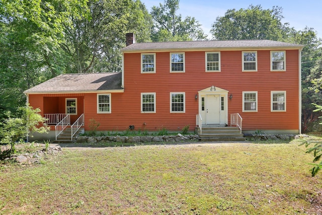 130 Sturbridge Ln, Fairfield, CT 06890 - colonial home with a chimney and a front yard