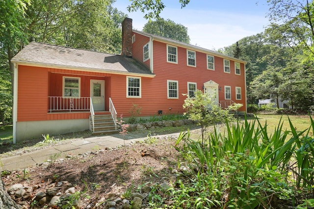 130 Sturbridge Ln, Fairfield, CT 06890 - colonial-style house featuring a chimney and covered porch