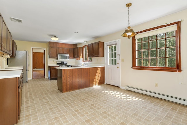 130 Sturbridge Ln, Fairfield, CT 06890 - kitchen featuring stainless steel appliances, light countertops, a baseboard radiator, a peninsula, and healthy amount of natural light