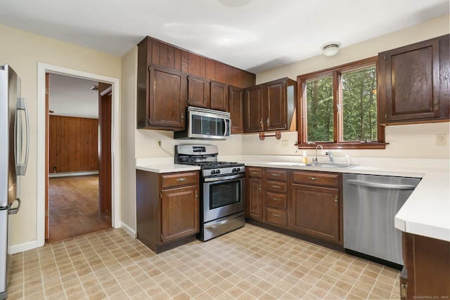 130 Sturbridge Ln, Fairfield, CT 06890 - kitchen featuring stainless steel appliances, light countertops, dark brown cabinetry, and a baseboard radiator