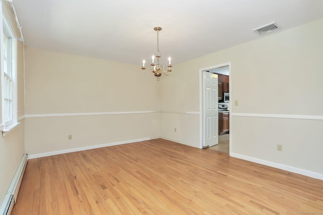130 Sturbridge Ln, Fairfield, CT 06890 - spare room with a baseboard heating unit, a chandelier, and light wood-style flooring