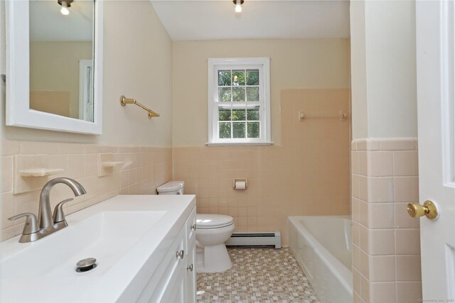 130 Sturbridge Ln, Fairfield, CT 06890 - bathroom with tile walls, baseboard heating, a tub, vanity, and wainscoting