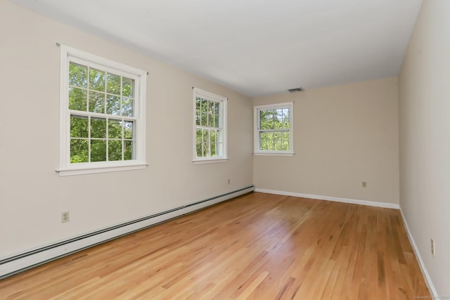 130 Sturbridge Ln, Fairfield, CT 06890 - empty room with a baseboard heating unit and light wood-style floors