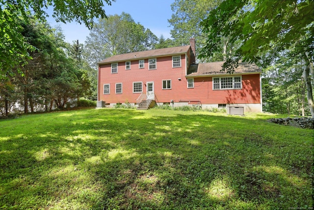 130 Sturbridge Ln, Fairfield, CT 06890 - back of house with a chimney, a lawn, and entry steps