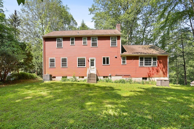 130 Sturbridge Ln, Fairfield, CT 06890 - back of property featuring a chimney, a lawn, entry steps, and a shingled roof