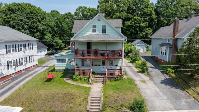 36 Carter St, Killingly, CT 06239 - view of front of property with driveway, a porch, a shingled roof, and a detached garage
