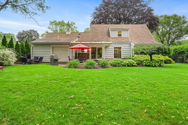 86 Lorma Ave, Trumbull, CT 06611 - back of house with a garage, a chimney, and a patio