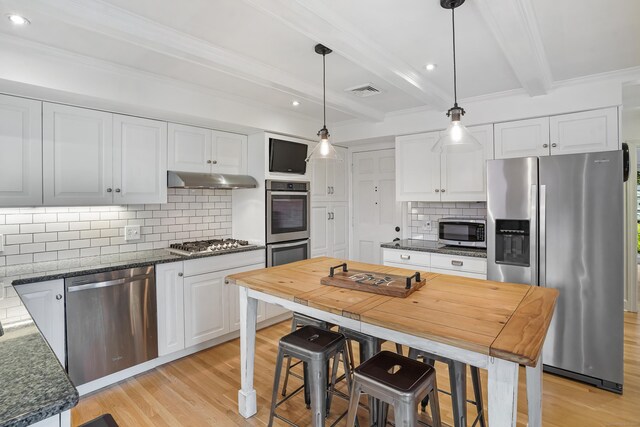 86 Lorma Ave, Trumbull, CT 06611 - kitchen featuring appliances with stainless steel finishes, light wood finished floors, beamed ceiling, white cabinetry, and decorative backsplash