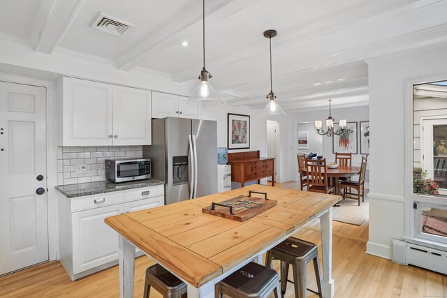 86 Lorma Ave, Trumbull, CT 06611 - kitchen with appliances with stainless steel finishes, beamed ceiling, a baseboard heating unit, light wood finished floors, and a chandelier