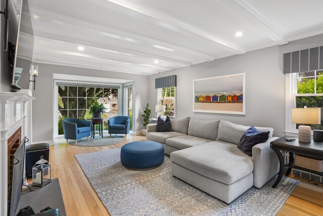 86 Lorma Ave, Trumbull, CT 06611 - living area featuring beam ceiling, a fireplace with flush hearth, light wood-style flooring, healthy amount of natural light, and recessed lighting