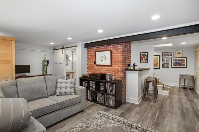 86 Lorma Ave, Trumbull, CT 06611 - living room with a barn door, wood finished floors, and recessed lighting