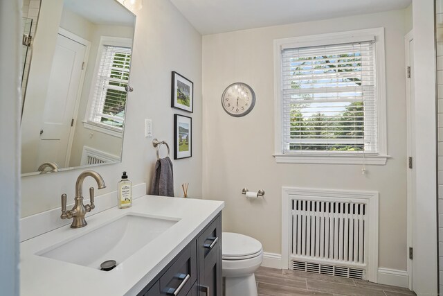 86 Lorma Ave, Trumbull, CT 06611 - bathroom featuring radiator, vanity, and wood finished floors