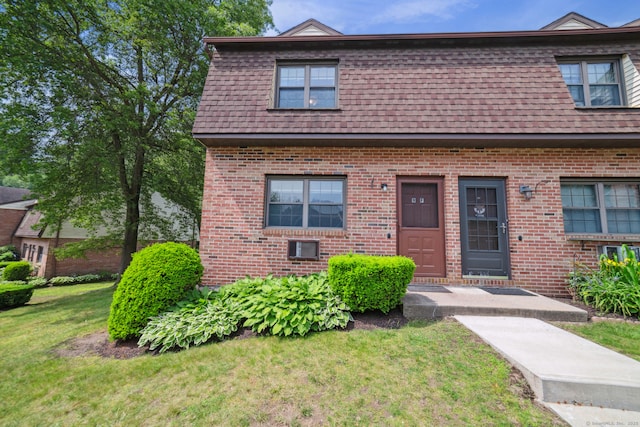143 Pine Hill Rd Unit 9F, Thomaston, CT 06787 - view of front of house with brick siding, a front lawn, and mansard roof