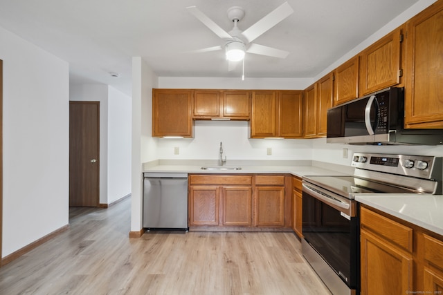 143 Pine Hill Rd Unit 9F, Thomaston, CT 06787 - kitchen with stainless steel appliances, a sink, light countertops, and light wood-style flooring