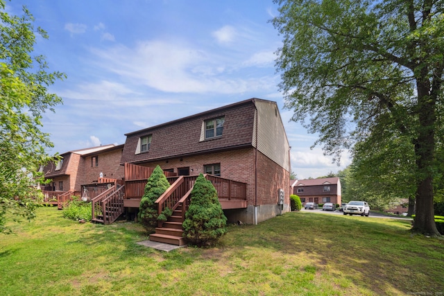 143 Pine Hill Rd Unit 9F, Thomaston, CT 06787 - rear view of house with brick siding, a yard, stairway, and a wooden deck