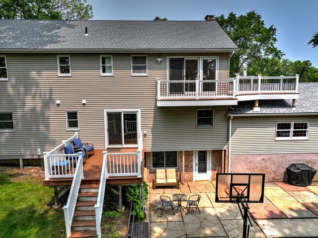 51 Crestwood Rd, Milford, CT 06460 - rear view of house with a patio area, a chimney, a wooden deck, and roof with shingles