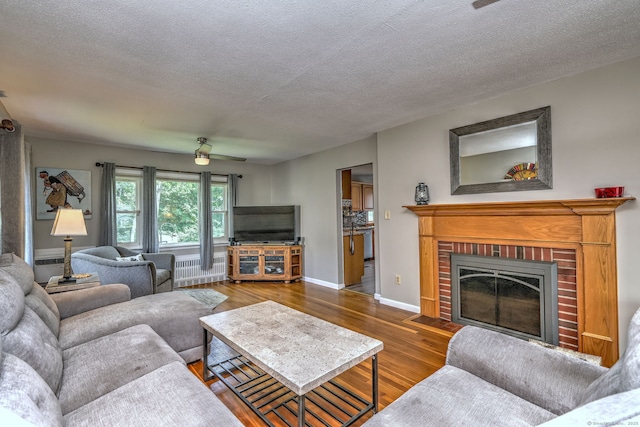 97 Richmond Ave, West Haven, CT 06516 - living area with wood finished floors, a fireplace, radiator, and a textured ceiling