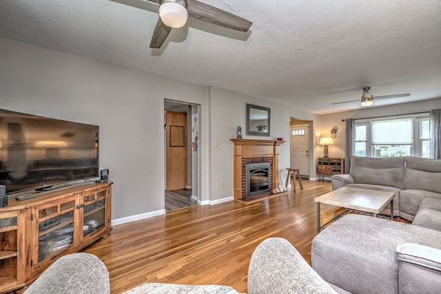 97 Richmond Ave, West Haven, CT 06516 - living room with a ceiling fan, wood finished floors, a fireplace, and a textured ceiling