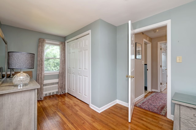 97 Richmond Ave, West Haven, CT 06516 - kitchen featuring radiator, light wood-style floors, and light countertops