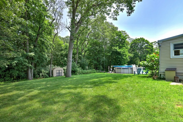 97 Richmond Ave, West Haven, CT 06516 - view of grassy yard featuring a storage unit and a covered pool