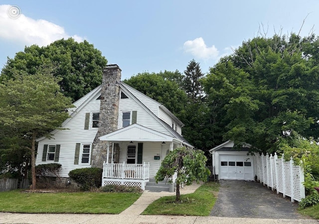 28 Highland Ave, Naugatuck, CT 06770 - view of front facade featuring a porch, an outbuilding, driveway, a chimney, and a detached garage