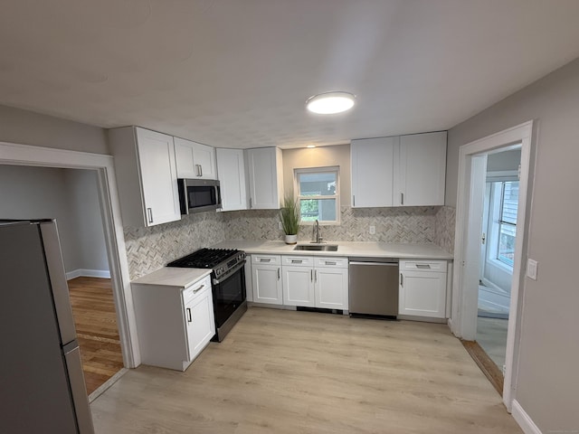 28 Highland Ave, Naugatuck, CT 06770 - kitchen with stainless steel appliances, decorative backsplash, light countertops, and white cabinets
