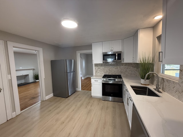 28 Highland Ave, Naugatuck, CT 06770 - kitchen featuring stainless steel appliances, light stone countertops, decorative backsplash, and light wood-style flooring