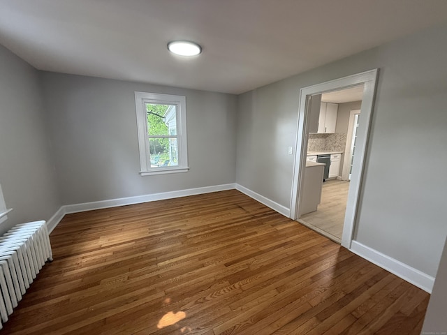 28 Highland Ave, Naugatuck, CT 06770 - spare room featuring radiator and wood finished floors