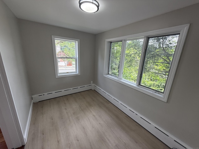 28 Highland Ave, Naugatuck, CT 06770 - empty room with plenty of natural light, a baseboard radiator, light wood-style floors, and baseboard heating