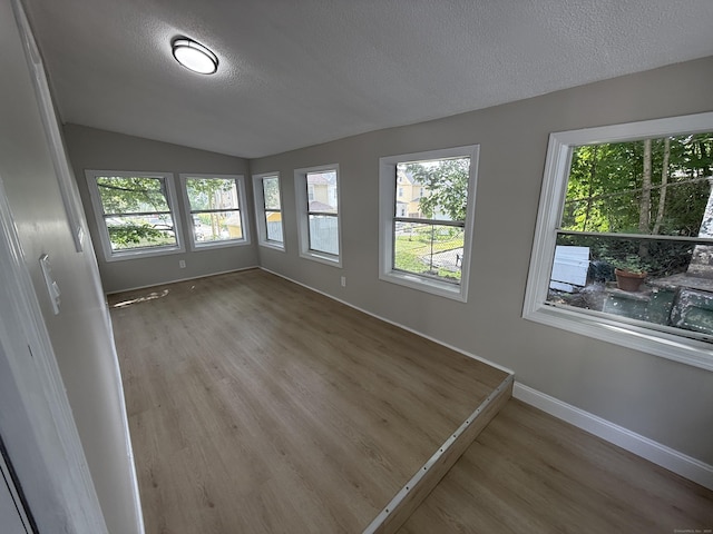 28 Highland Ave, Naugatuck, CT 06770 - empty room with wood finished floors, a textured ceiling, and lofted ceiling