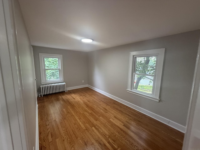 28 Highland Ave, Naugatuck, CT 06770 - spare room featuring radiator and wood finished floors