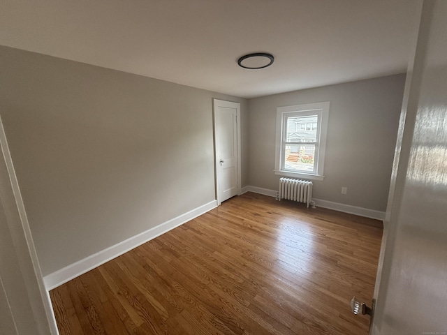 28 Highland Ave, Naugatuck, CT 06770 - spare room featuring radiator and wood finished floors