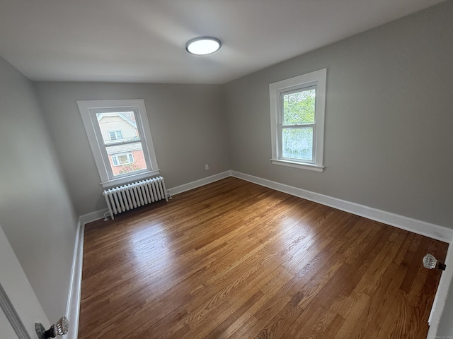 28 Highland Ave, Naugatuck, CT 06770 - spare room with radiator heating unit and wood finished floors