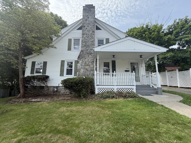 28 Highland Ave, Naugatuck, CT 06770 - view of front of property with covered porch, a front yard, and a chimney