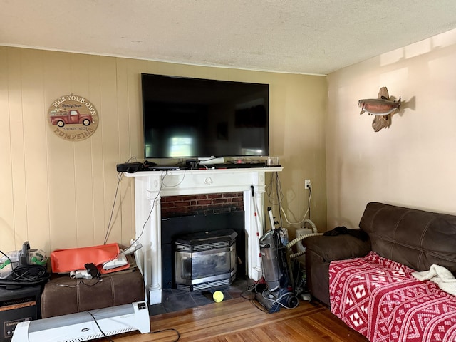 451 Robbins Ave, Newington, CT 06111 - living room featuring wood finished floors, a wood stove, and a textured ceiling