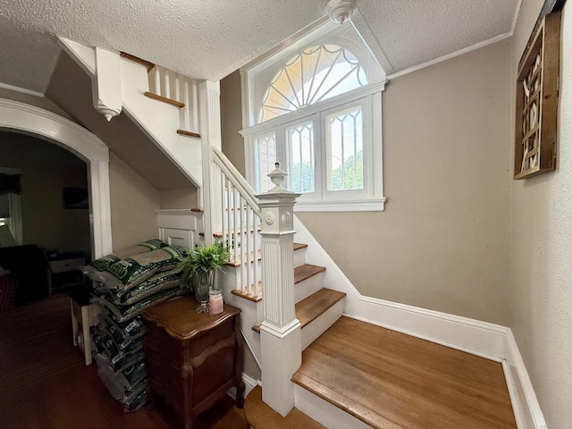 451 Robbins Ave, Newington, CT 06111 - stairs featuring a textured ceiling, wood finished floors, and baseboards