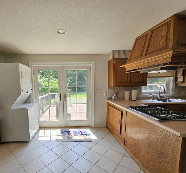 105 Minortown Rd, Woodbury, CT 06798 - kitchen featuring stacked washer / drying machine, stainless steel gas stovetop, french doors, healthy amount of natural light, and a textured ceiling