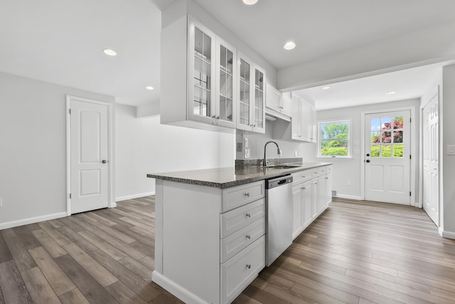 22 Allerton Rd, Naugatuck, CT 06770 - kitchen with stainless steel dishwasher, a sink, wood finished floors, glass insert cabinets, and white cabinetry