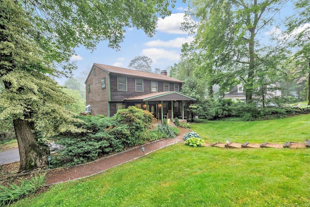 136 Wheeler Rd, Monroe, CT 06468 - back of house featuring a chimney, a lawn, and a porch