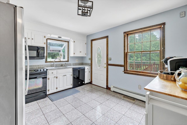 136 Wheeler Rd, Monroe, CT 06468 - kitchen featuring black appliances, baseboard heating, light countertops, and healthy amount of natural light