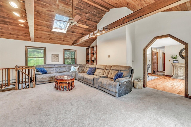 136 Wheeler Rd, Monroe, CT 06468 - carpeted living room with a wooden ceiling with exposed beams, a ceiling fan, a skylight, high vaulted ceiling, and a baseboard radiator