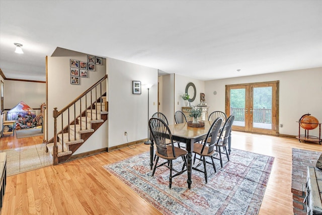136 Wheeler Rd, Monroe, CT 06468 - dining area with light wood-type flooring, stairway, and french doors