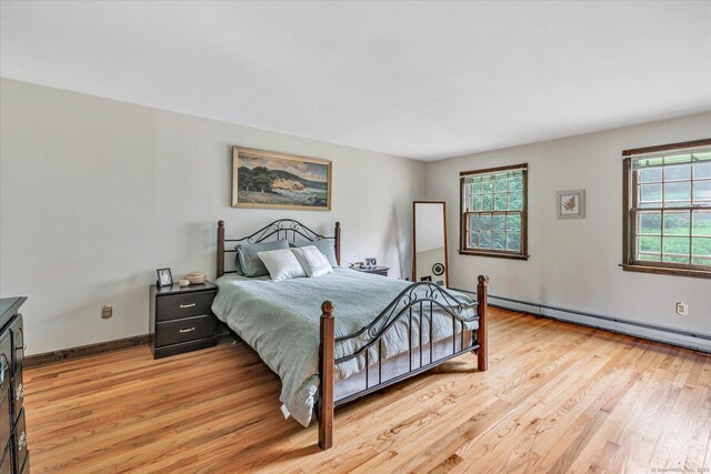 136 Wheeler Rd, Monroe, CT 06468 - bedroom with light wood-type flooring and baseboard heating