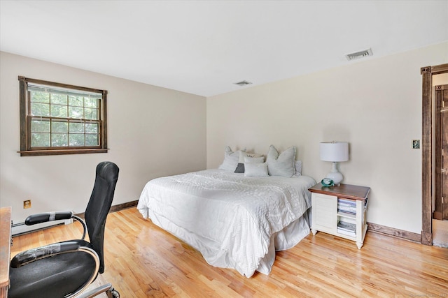 136 Wheeler Rd, Monroe, CT 06468 - bedroom with wood finished floors, a desk, and a baseboard heating unit