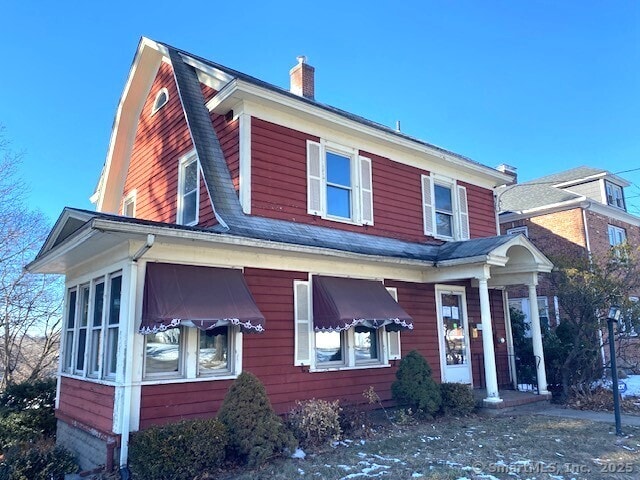 242 Pearl St, Enfield, CT 06082 - view of front facade with a gambrel roof and a chimney
