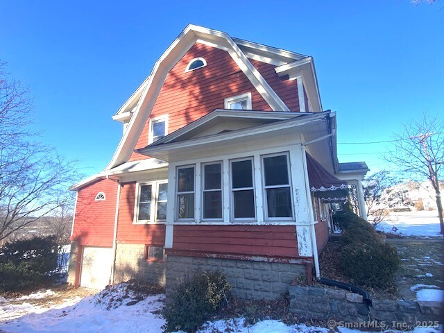242 Pearl St, Enfield, CT 06082 - view of snow covered exterior featuring a gambrel roof