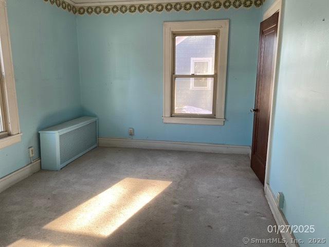 242 Pearl St, Enfield, CT 06082 - empty room featuring carpet flooring, radiator, and baseboards