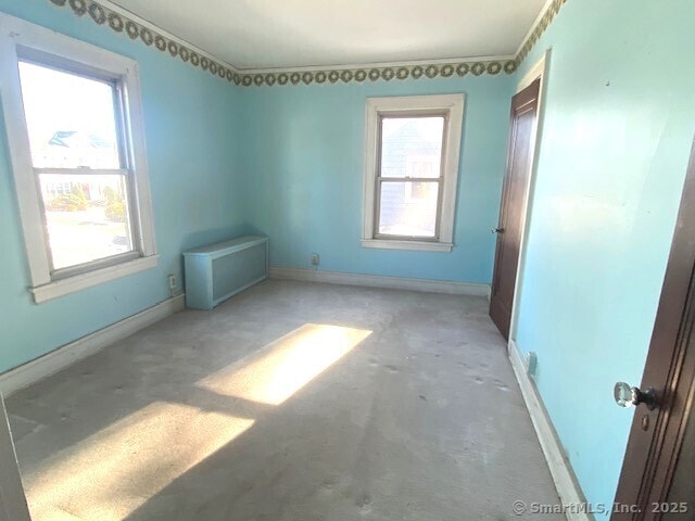 242 Pearl St, Enfield, CT 06082 - unfurnished bedroom with baseboards and unfinished concrete flooring