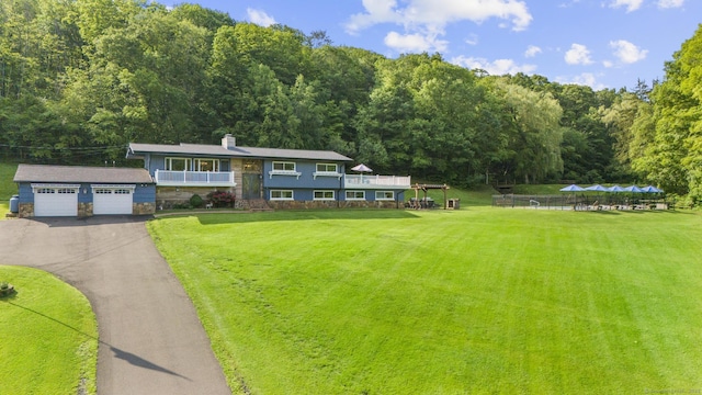 408 Stage Coach Rd, Durham, CT 06422 - view of front facade featuring a front yard, a chimney, a wooded view, and stone siding